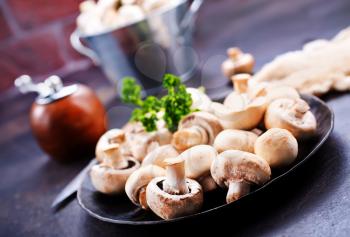 raw mushrooms, raw champignons, champignons on a table, stock photo