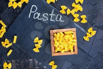 raw pasta on a table, background with raw pasta