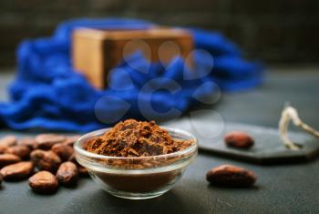 cocoa beans and cocoa powder on a table