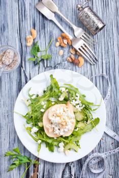 Salad with green arugula plant, pear and cottage cheese 
