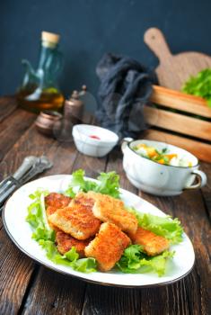 fish nuggets with latuk salad on plate, fried nuggets
