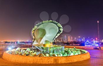 Doha, Qatar: December 24, 2017: The Oyster and Pearl Fountain on Corniche Seaside Promenade. One of the symbols of modern Doha