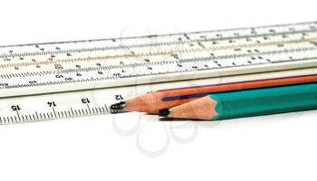 Pencils and slide rule isolated on white background
