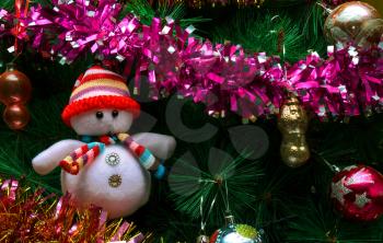 Artificial Christmas tree with Christmas decorations toys and a snowman