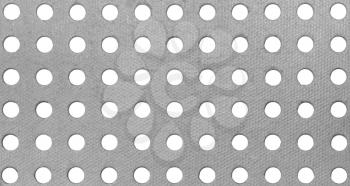 A pattern from a gray cardboard background with holes