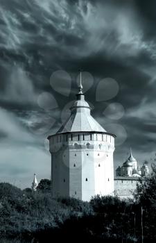 Watch tower of Spaso-Prilutsky Monastery in the Vologda city, Russia. Dramatic view. Monochrome image. Castle defense wall