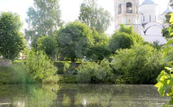 Courtyard pond of Spaso-Prilutsky Monastery in the Vologda city, Russia. Summer sunny day. Bell tower