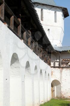 Arcade of the ancient courtyard of Spaso-Prilutsky Monastery at summer sunny day in in the Vologda, Russia. Castle defense wall