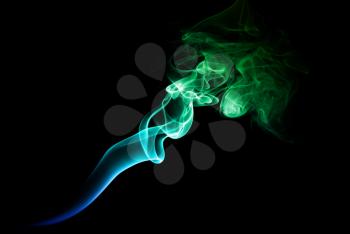 Green and blue smoke on a dark background.