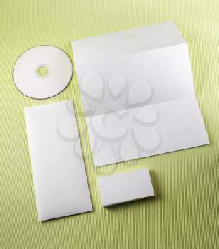 Blank corporate identity set on a green background. Top view.