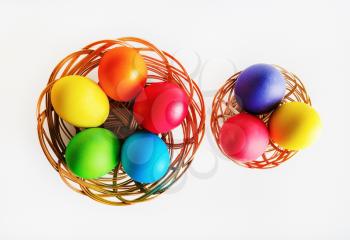 Colorful easter eggs. Two baskets with colored Easter eggs. Top view.