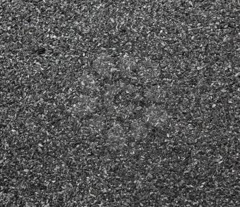 Abstract dark granular background. Close-up abrasive texture roofing material.