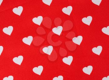 Hearts pattern on red fabric texture background. Hearts on the cloth. Valentine's day concept.