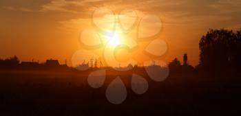 Orange sunset in the countryside. Russian village.