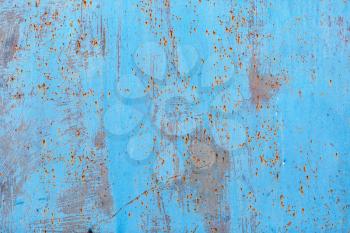 Peeling paint texture with rust stains. Old blue grunge background.