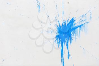 A large blue blot on the background of white plastered wall