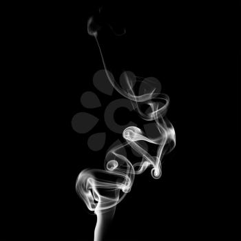 Abstract white smoke swirls on black background. Photo.