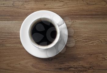 Coffee cup on wood table background. Copy space. Top view.
