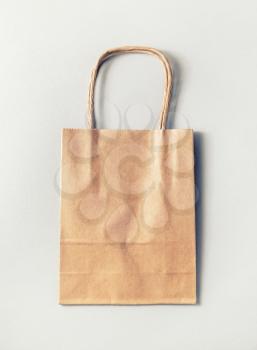 Recycled paper shopping bag on paper background.