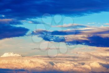 Scenic sunset sky with picturesque cumulus clouds.