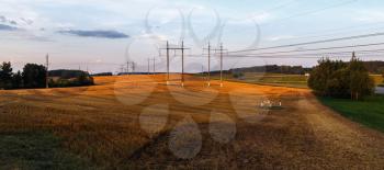 Field after harvest in the countryside. Scenic rural landscape at sunset. Panorama shot.