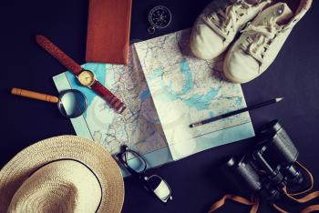 Outfit, equipment and accessories of traveler. Travel concept background. Vintage toned image. Top view. Flat lay.