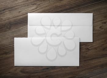 Two blank envelopes on wooden background. Front and back side. Flat lay.