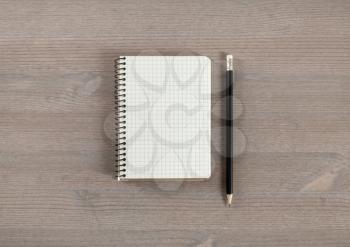 Photo of blank notepad and pencil on wooden background. Responsive design mockup. Flat lay.