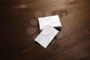 Blank white business cards on wood table background. Mockup for branding identity.