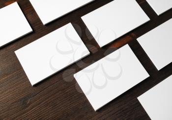 Blank business cards on wood table background. Template for branding identity.