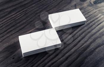 Stacks of blank business cards on vintage wood background. Template for ID. Blank objects for placing your design.