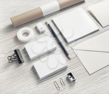 Blank corporate identity template on light wood table background.