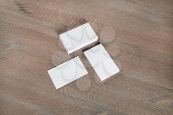 Photo of blank business cards on wooden background. Template for ID.