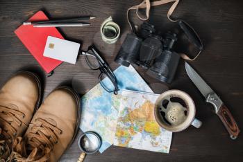 Outfit of traveler on wooden background. Tourism concept. Travel accessories and items. Top view. Flat lay.