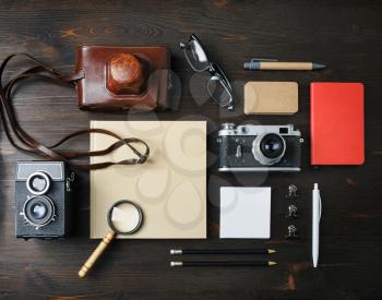 Travel stationery and retro camera on wood table background. Flat lay.