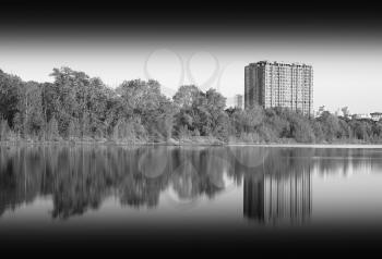 Black and white building on river backdrop