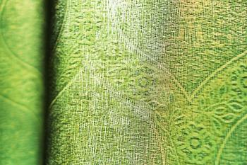Horizontal vivid green fabric bokeh background
