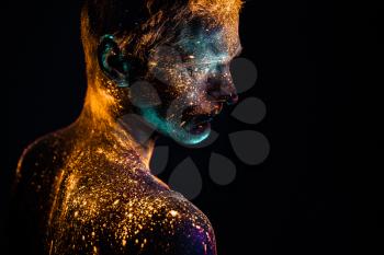 Conceptual shot of light and shine fluorescent  colors young man's face