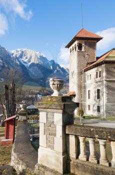 Cantacuzino Castle and the Carpathian Mountains in a sunny day. Residence and museum in a Transylvanian Busteni city, Romania