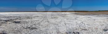 White Salty drying lake under the blue sky in Rybakovka, Odessa region, Ukraine. Big size panoramic photo