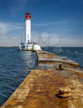 Lighthouse at the entrance to the harbor of Odessa seaport, on a sunny summer day