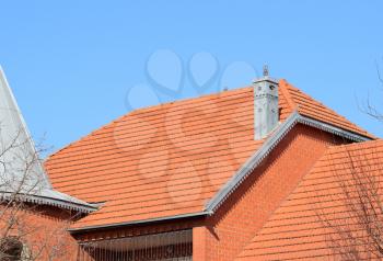 The house with a roof of tiles. The house with gables, windows and tiled roof, equipped with overflow.
