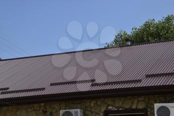 The roof of corrugated sheet. Roofing of metal profile wavy shape.