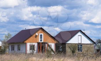 The roof of corrugated sheet on the houses. Individual homes with roof made of profiled sheet metal.