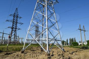 Power line support, insulators and wires. Appearance of a design. Assembly and installation of new support and wires of a power line.