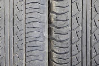 The background of the tread pattern of the car wheel. Rubber tires.