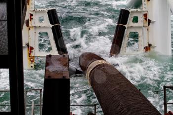 Descent of the pipeline to a bottom exhausting with the pipelaying barge. Installation of the underwater gas pipeline.