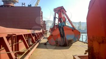 The deck of the vessel on which the ladle of the loading crane lies. Industrial port loading equipment.