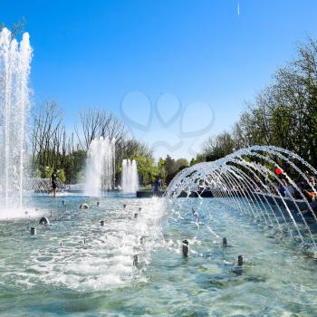Krasnodar, Russia - May 1, 2017: City fountain in the city of Krasnodar. People are walking by the fountain. Water splashes.
