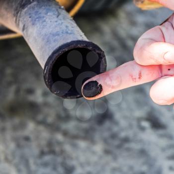 Soot from the exhaust pipe on the finger. Examination of the car's exhaust system by the automaker.